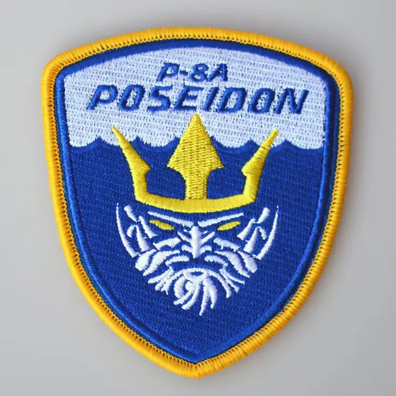 Custom embroidered / woven patch — iron-on, velcro, sew-on backing